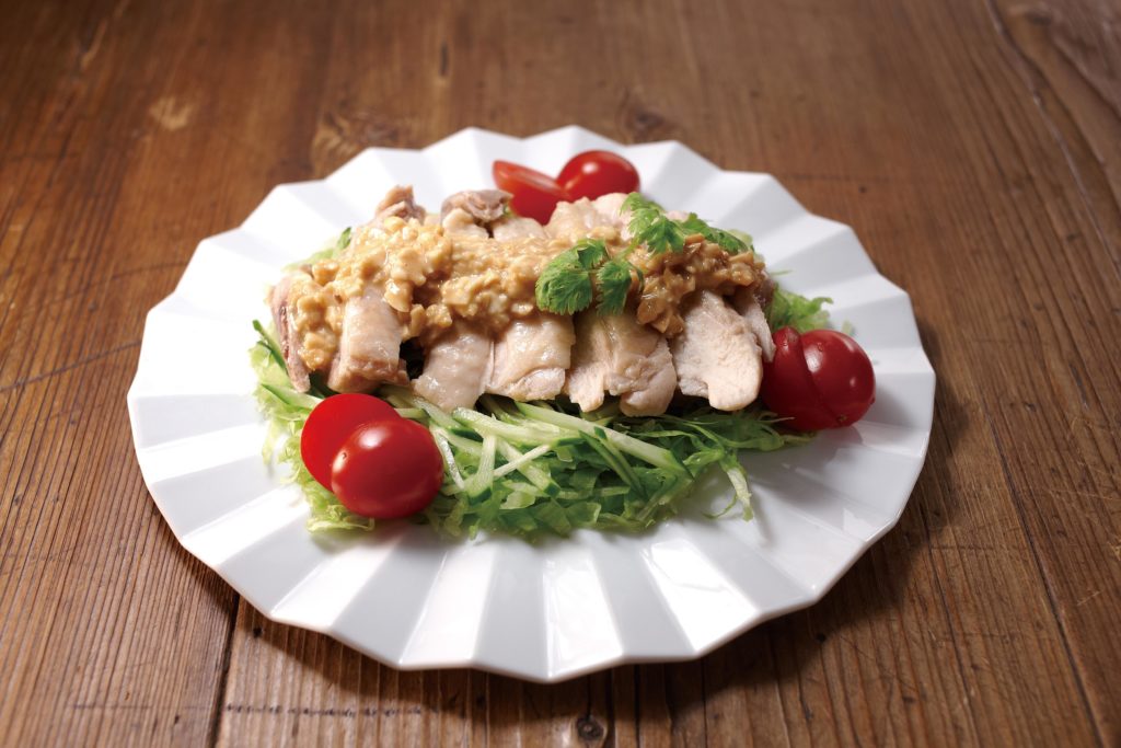 Bang bang chicken is a dish consisting of steamed and sliced chicken served over julienned cucumber - with a savory, nutty, sweet (and sometimes spicy) dressing. #chickenrecipe #japanesefood | Tiger USA