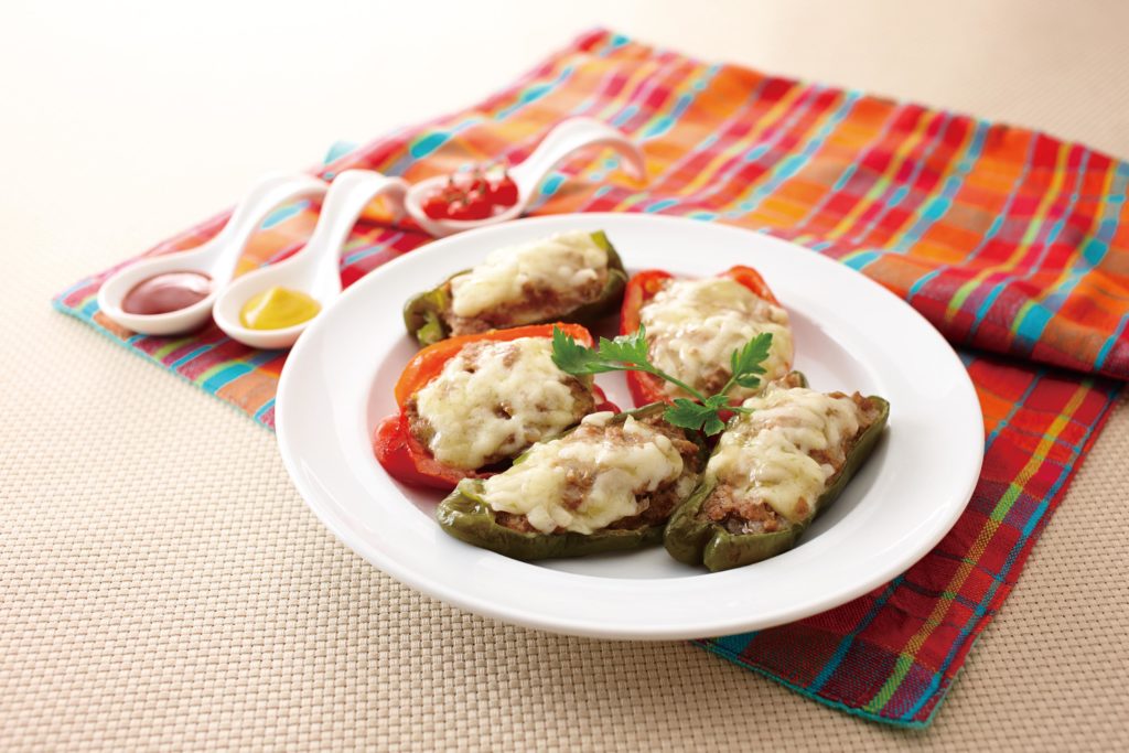 Stuffed Bell Peppers - These yummy stuffed bell peppers are brimming with a savory mixture of ground beef and pork. Onions and milk-soaked bread crumbs keep the interior moist. The whole things is topped with delicious ooey-gooey melted cheese. #sidedish #stuffedpeppers #groundbeefrecipe | Tiger USA